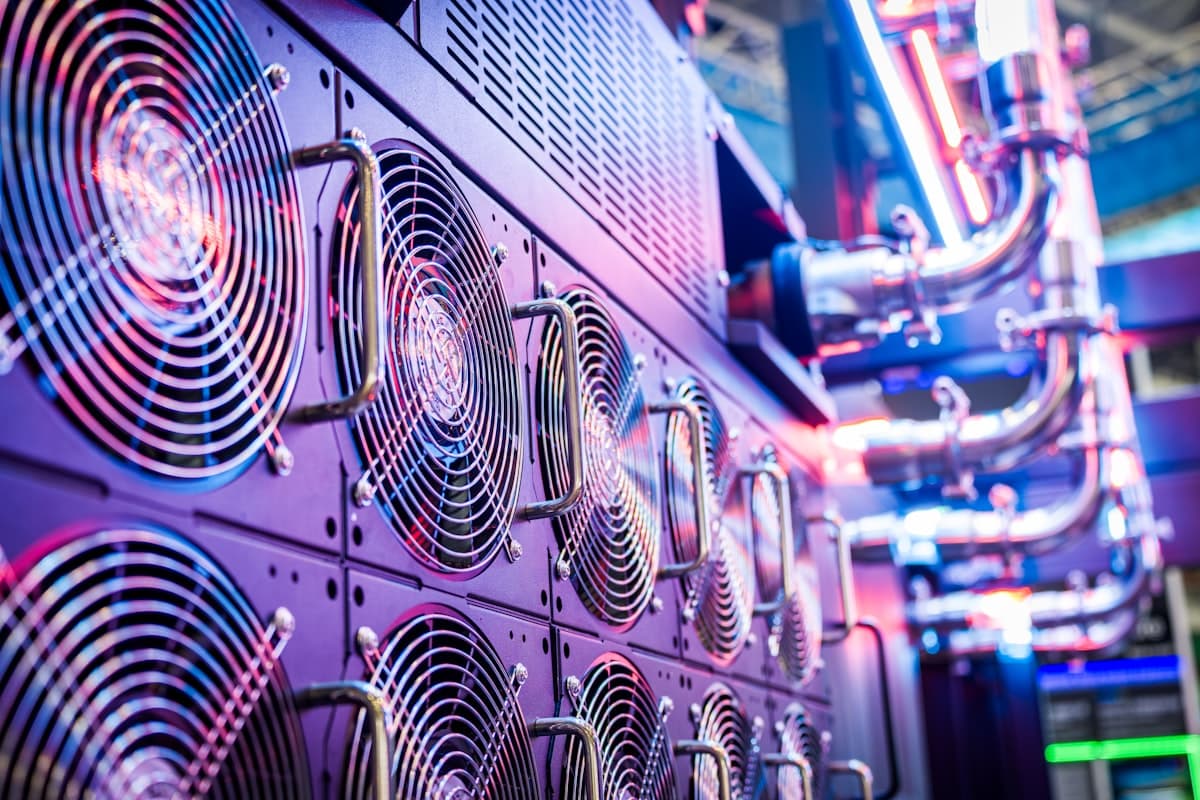 Rows of high-density compute units running under coloured light